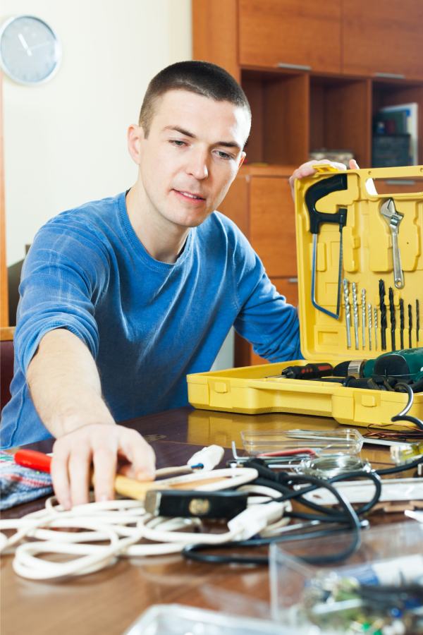 handsome man with toolbox reaching hammer